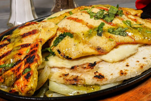 Cali Aji Latin Kitchen & Bakery Breakfast Arepas con Pollo. Colombian Corn Cake with Chicken